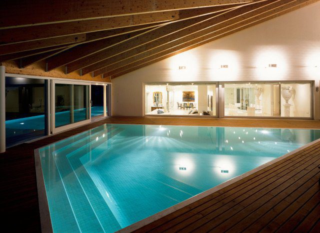 Indoor swimming pool with wood panelling