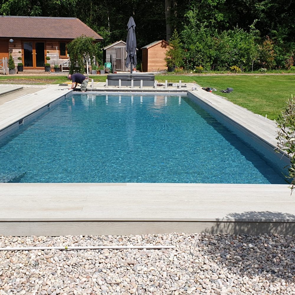 Outdoor swimming pool installation in Surrey with aquamatic cover