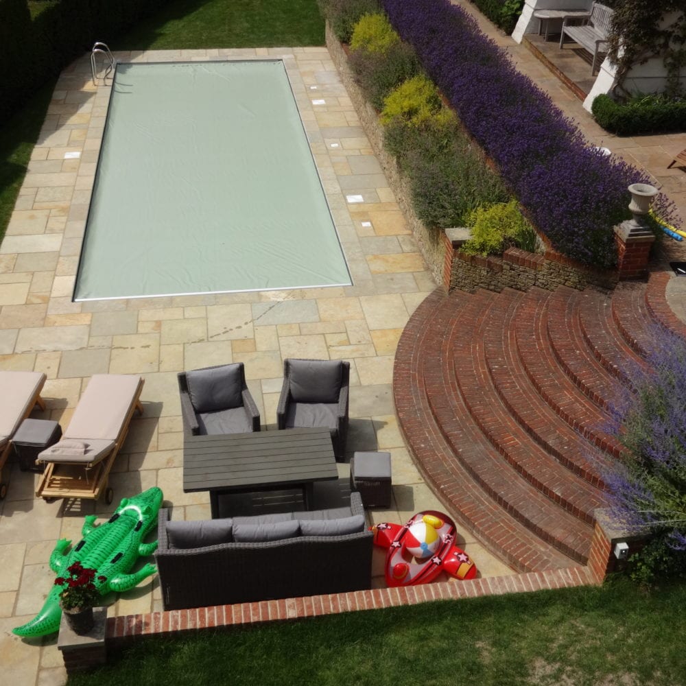 Paving and surround of outdoor pool with swimming cover