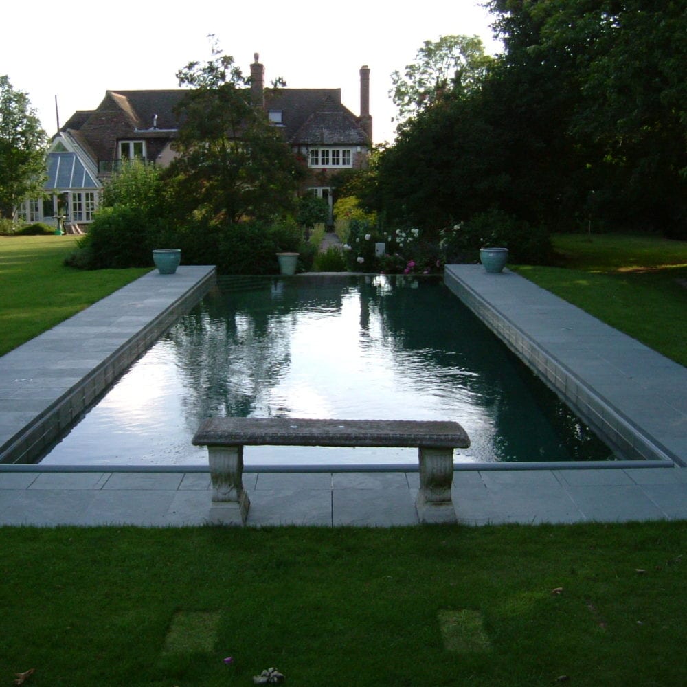 Simple outdoor pool with rustic bench