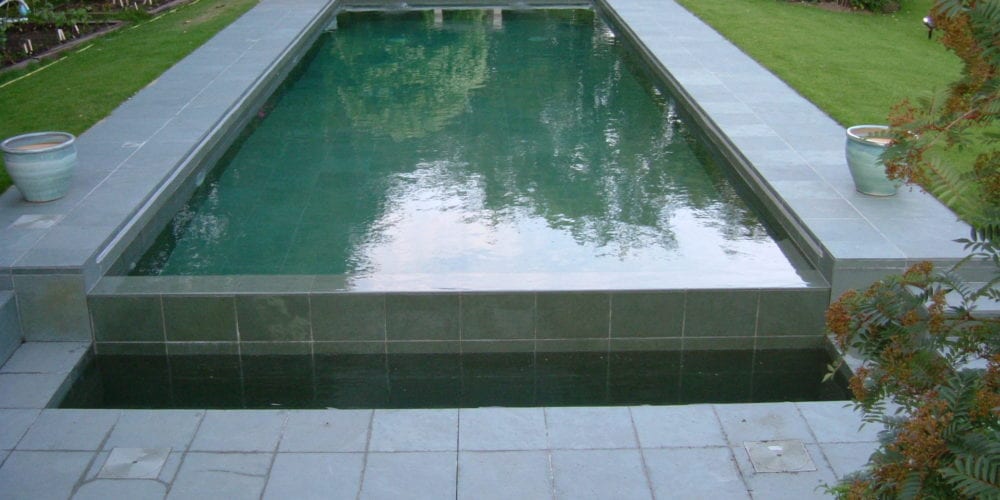 Outdoor swimming pool with automatic cover
