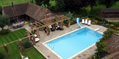 Swimming pool with paving and slide
