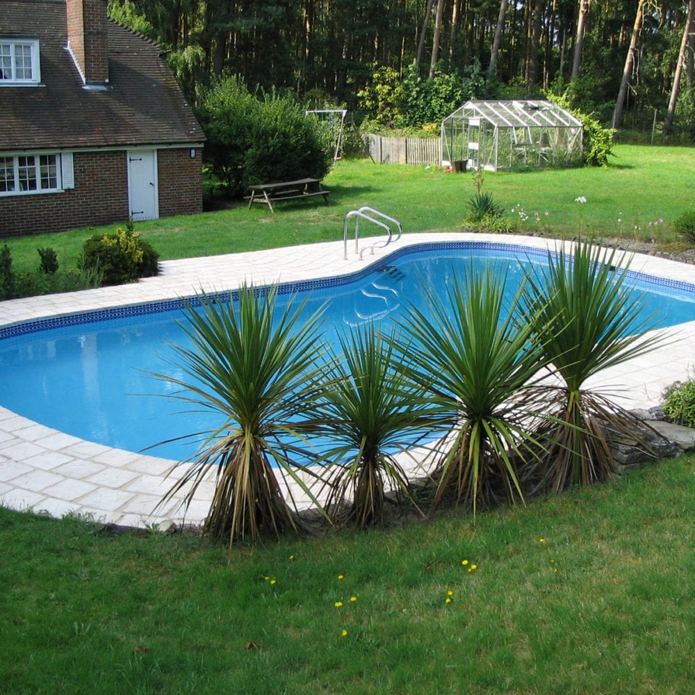 Rounded swimming pool with grab rail and mosaic tile