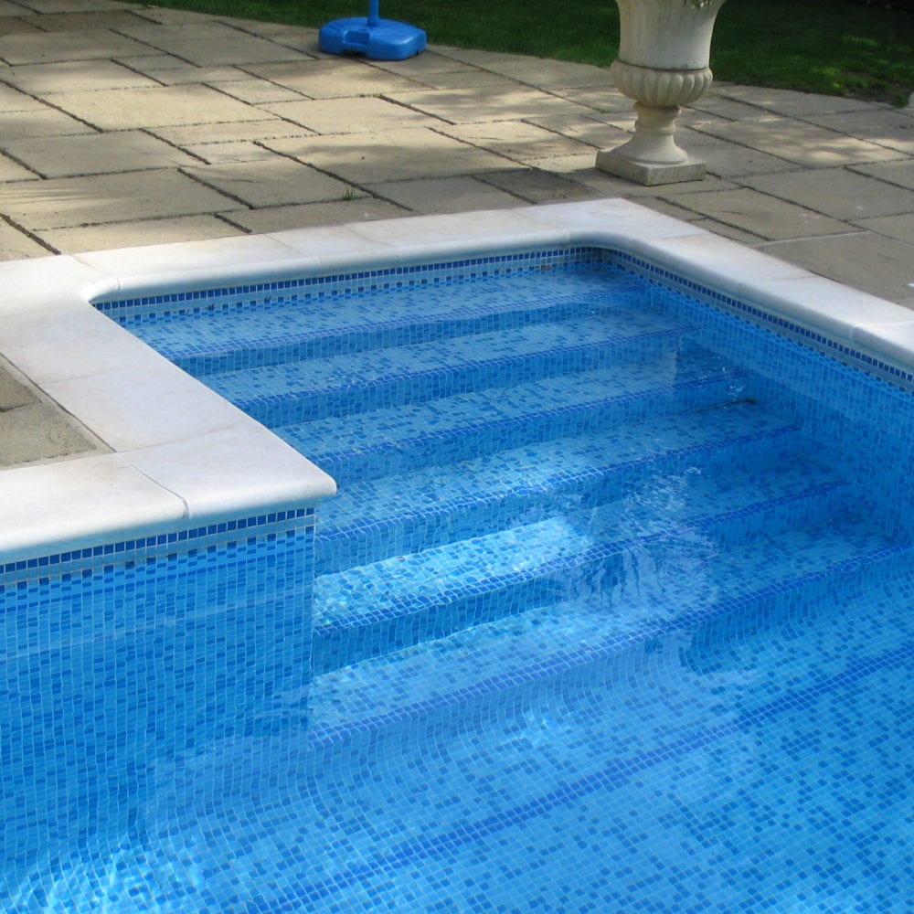 Rounded coping and mosaic tile steps in new pool
