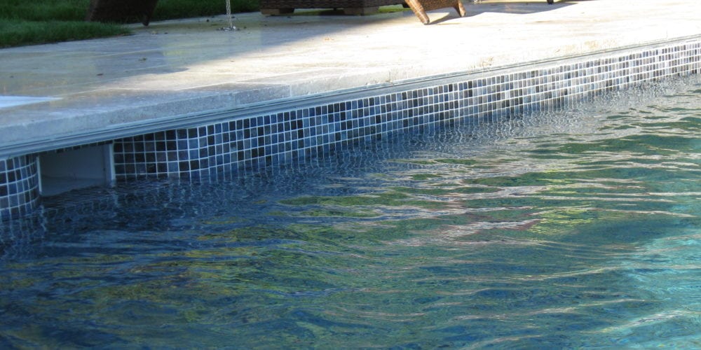 Mosaic tile pool installation with coping