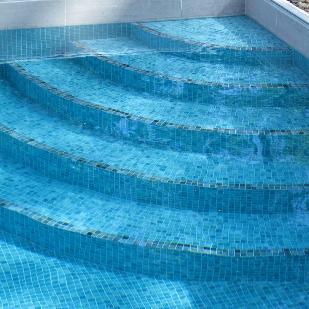Mosaic tiled concentric steps in new pool installation
