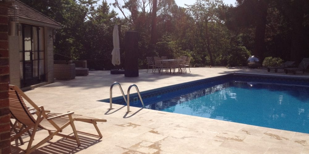 Paving pool surround in Surrey with deckchair and grabrail