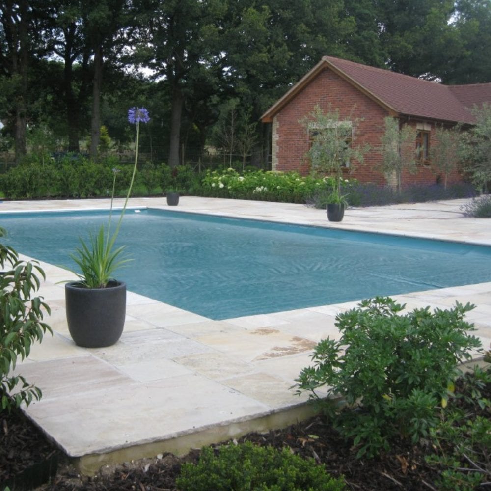 Swimming pool installation with paving and grabrail