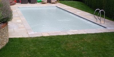 Covered outdoor swimming pool with grabrail