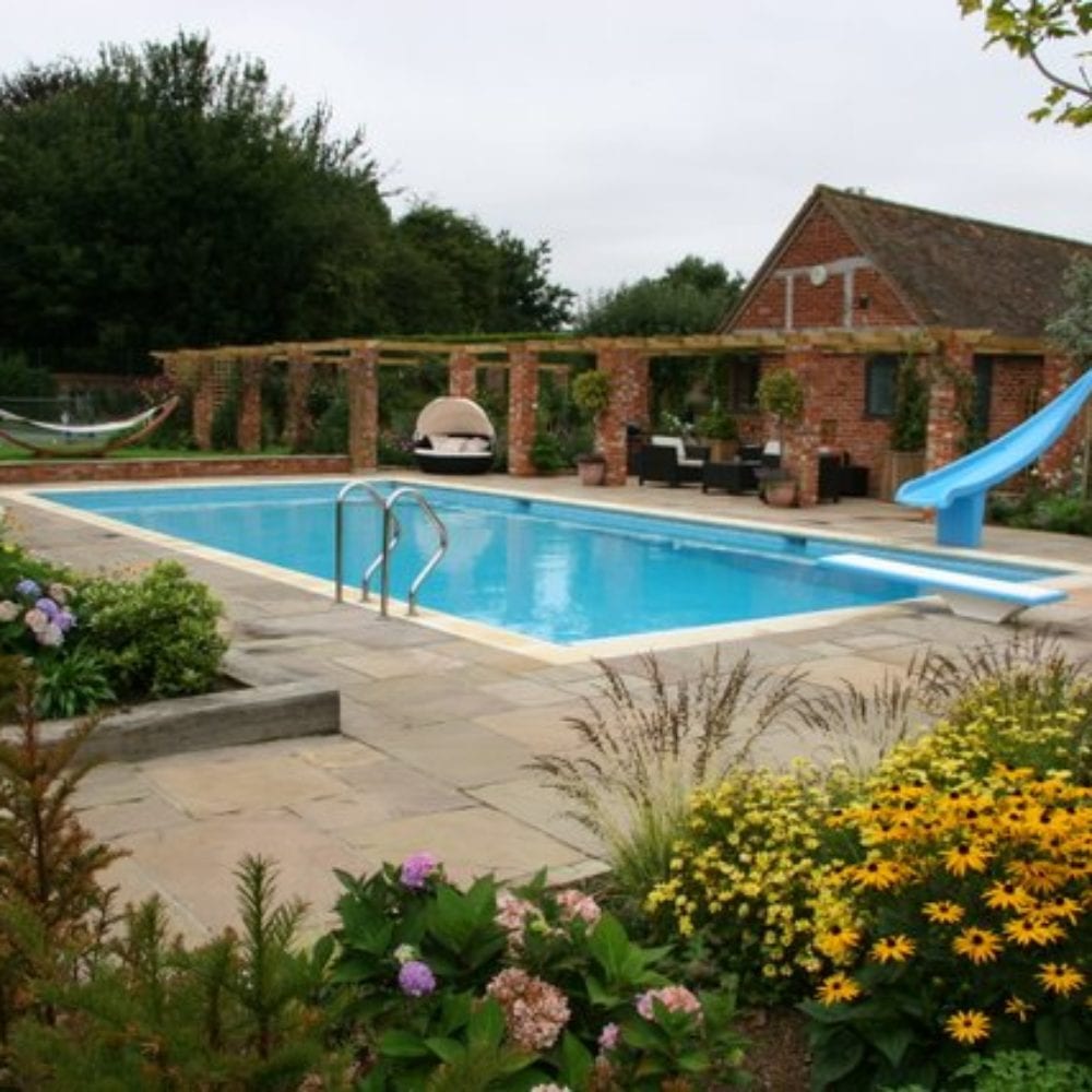 Outdoor swimming pool with slide and short diving board