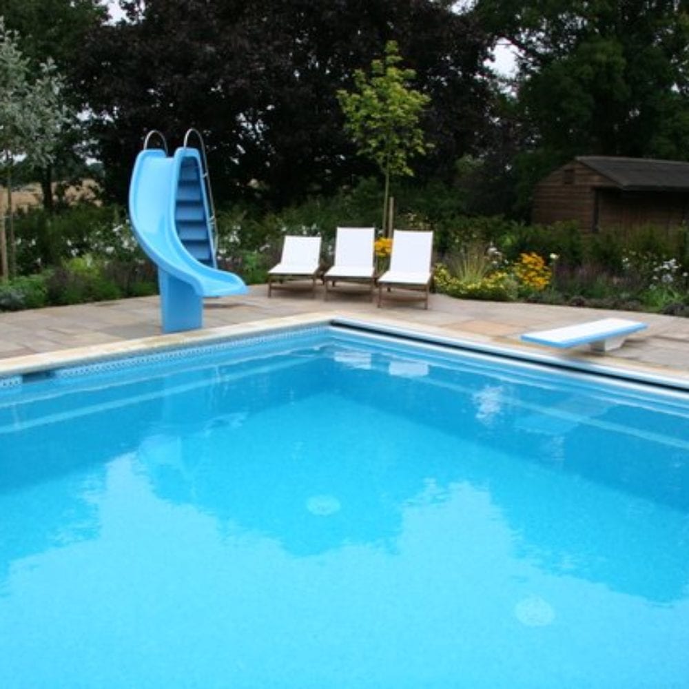 Outdoor swimming pool with slide and short diving board