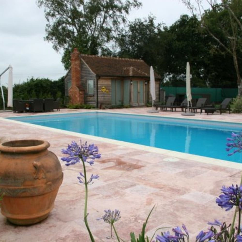 Outdoor Swimming Pool with Paving and Flowers