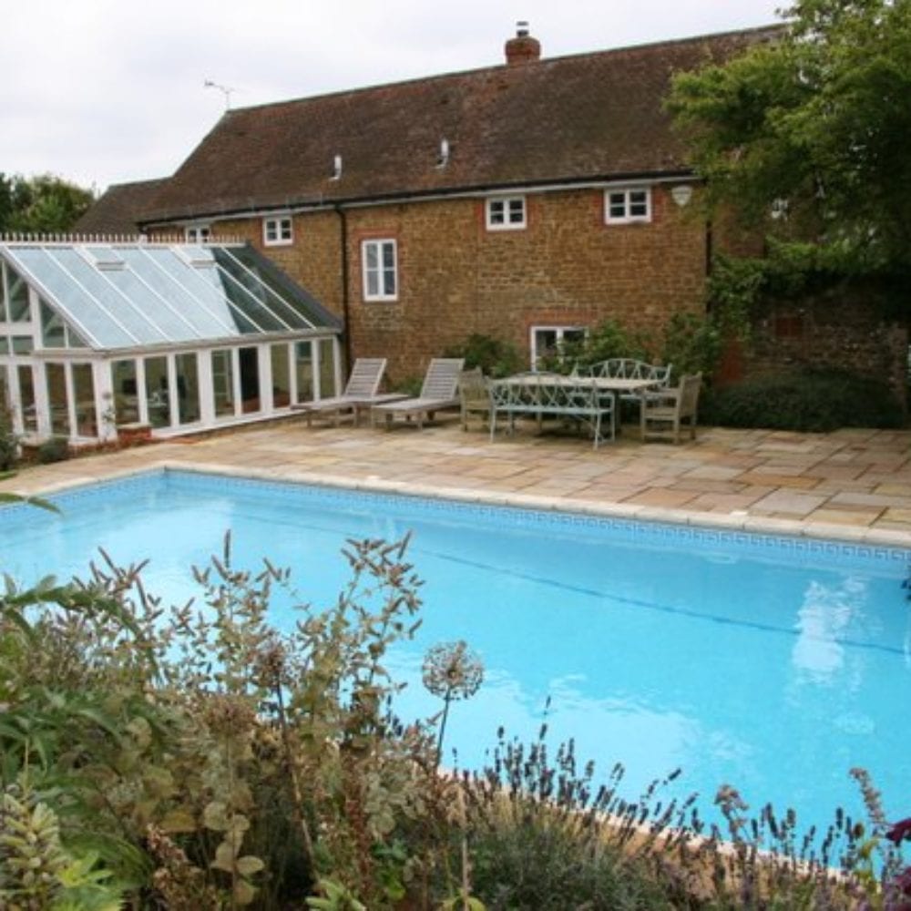 Outdoor swimming pool with simple paving