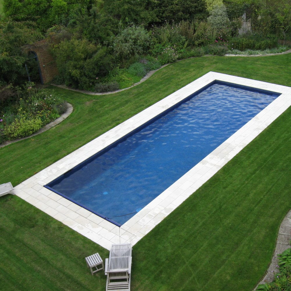 Outdoor Pool in Back Garden with White Paving