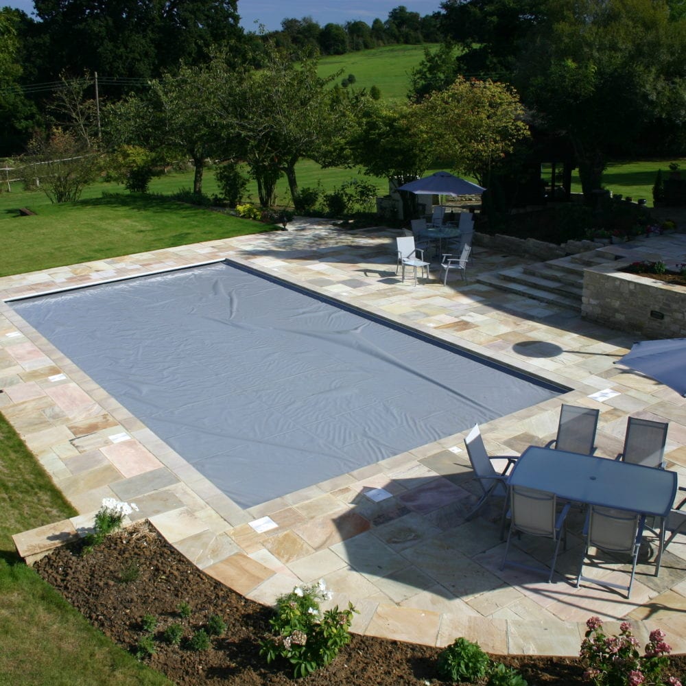 Outdoor swimming pool installation in Surrey with aquamatic cover