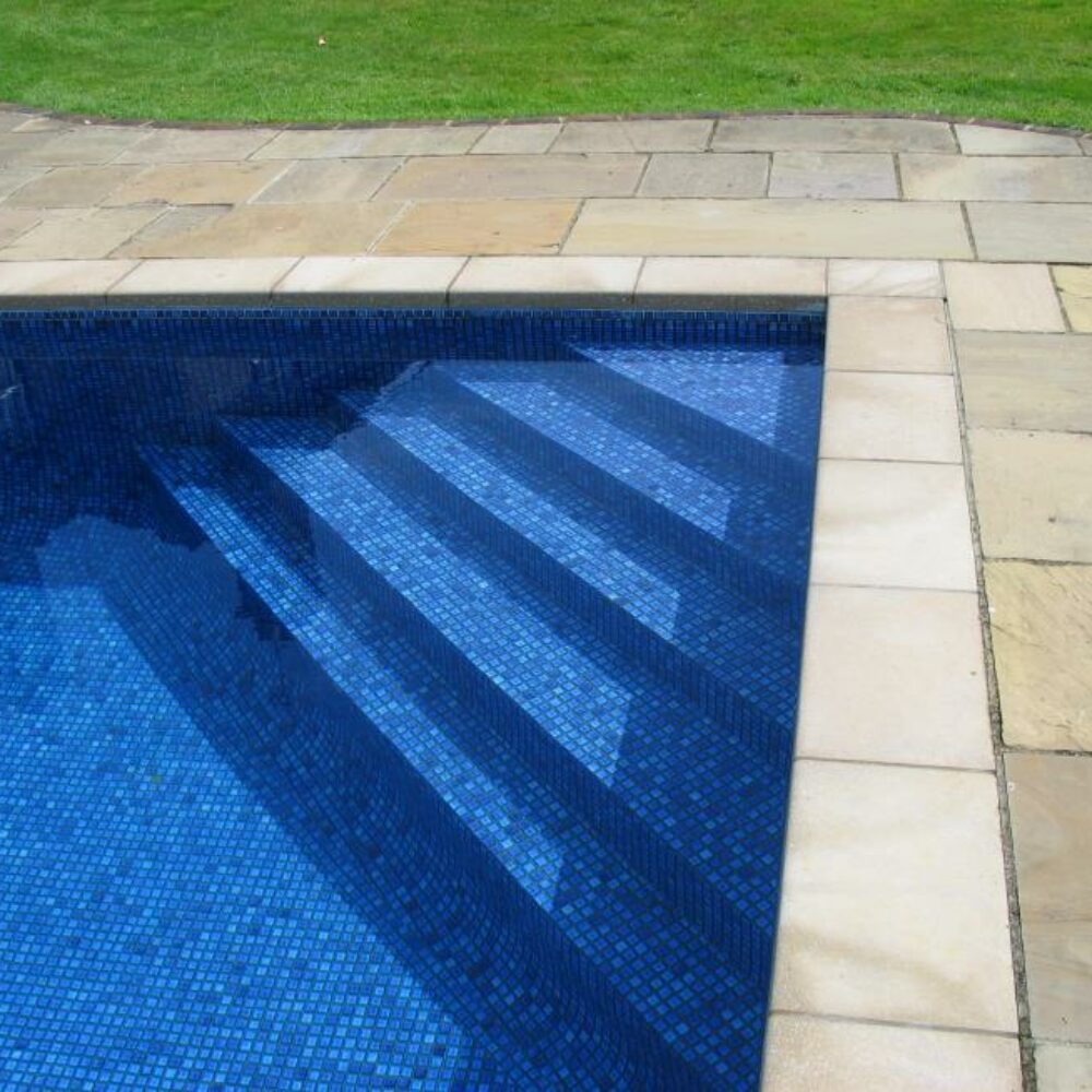 Corner Steps of Outdoor Swimming Pool with Blue Mosaic Tiles