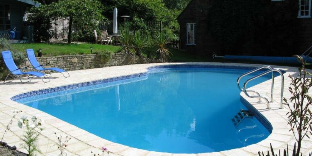New Rounded Swimming Pool with Tiling in Surrey